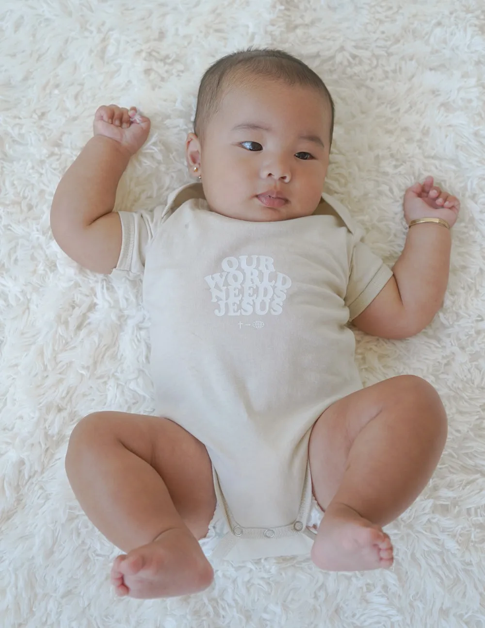 Our World Needs Jesus Beige Onesie